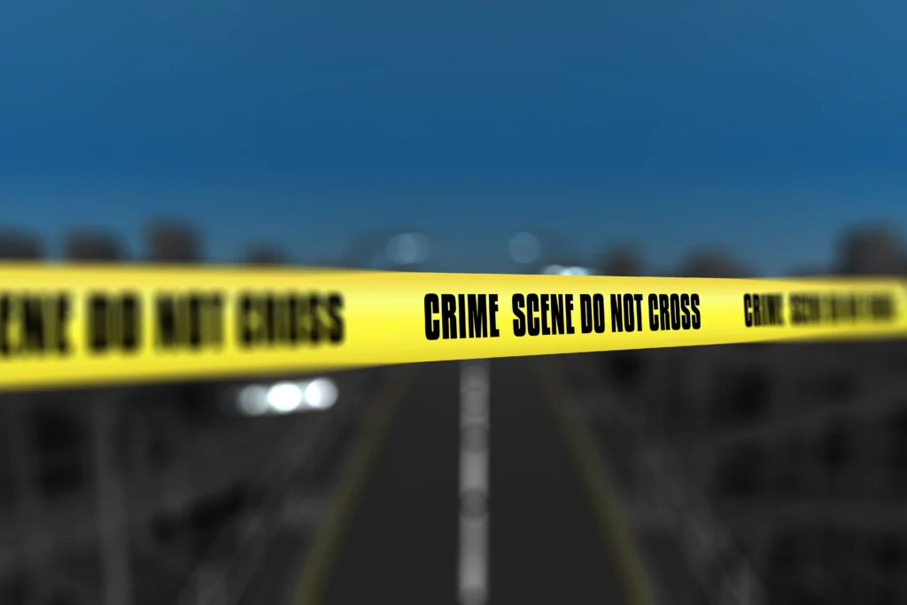 3d render crime scene tape against blurred city background