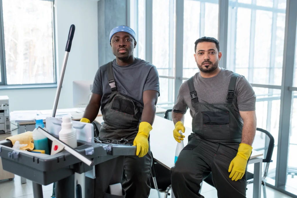 medium shot workers with cleaning cart