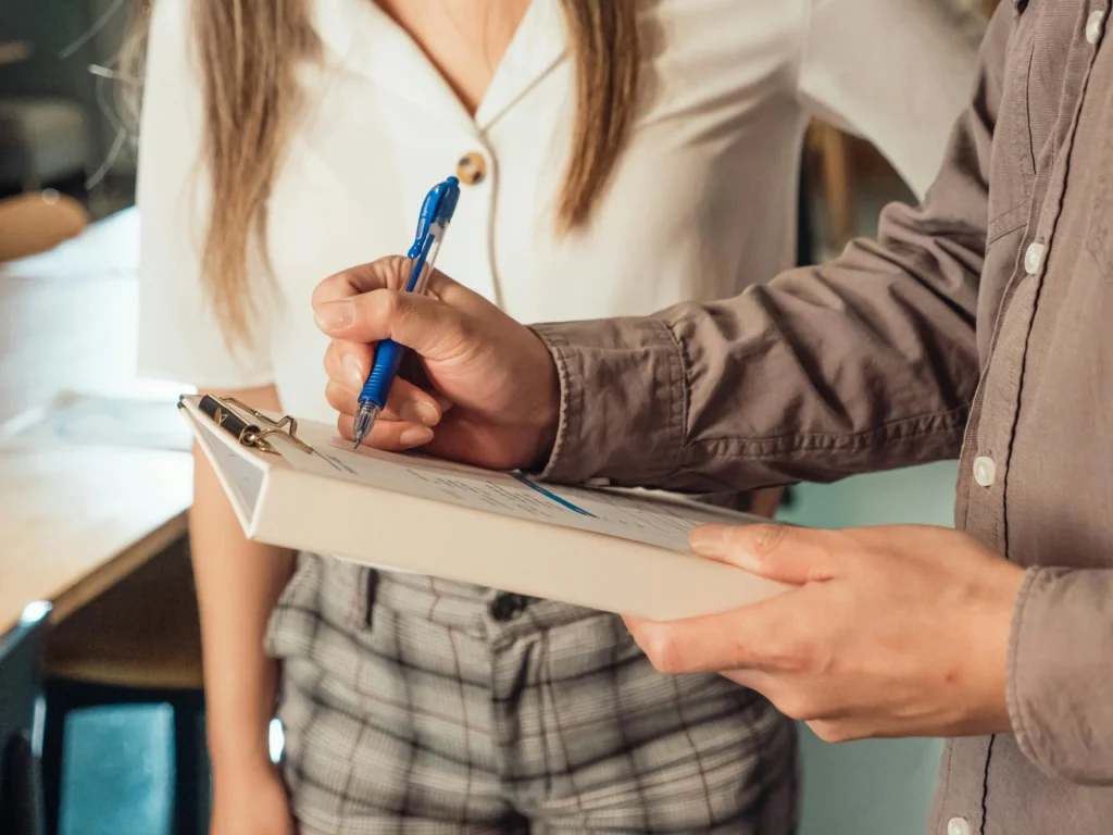 Man filling the ultimate office cleaning checklist